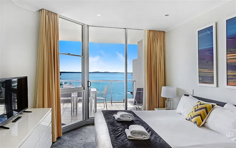 Sunlit living area with ocean views at Sandcastle Apartments